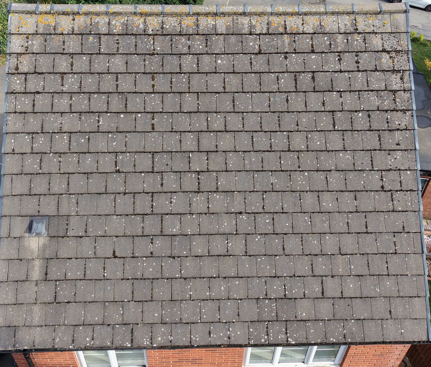 An aerial photograph of a complete tiled roof, showing the ridge, roof slope and eaves