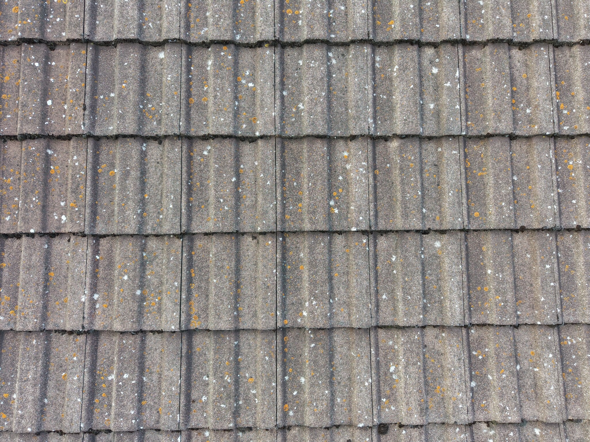 A drone photograph showing several rows of concrete roof tiles